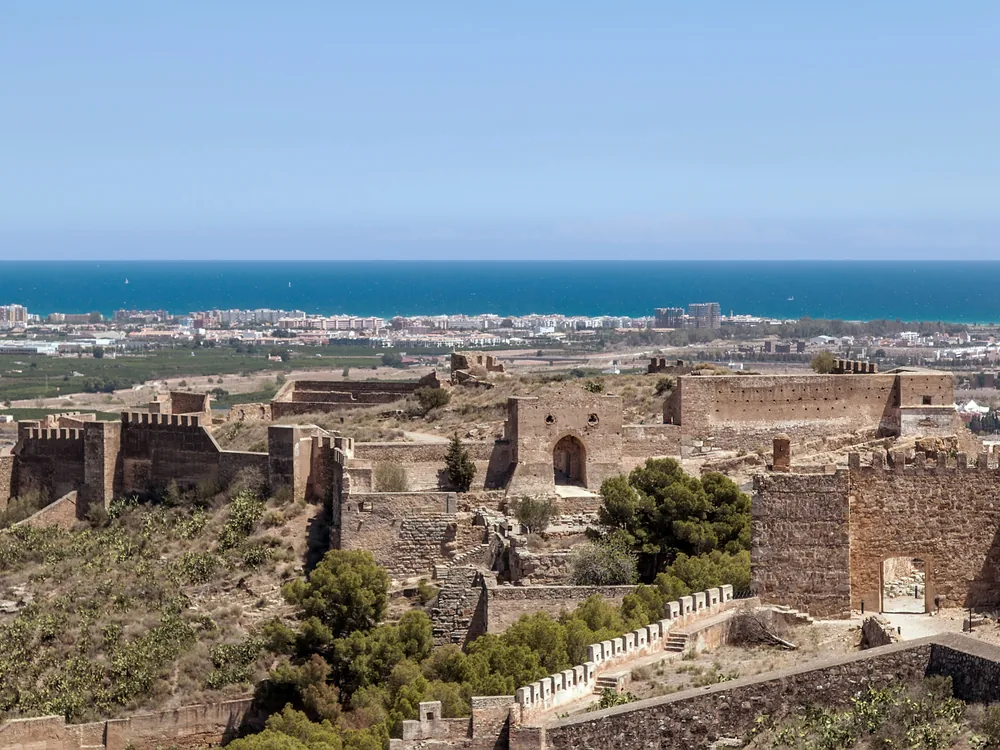 Sagunto Castle on the limestone ridge above Sagunto — the 7-hectare multi-period fortress where Hannibal's 219 BC siege of Saguntum triggered the Second Punic War, 25km from Valencia