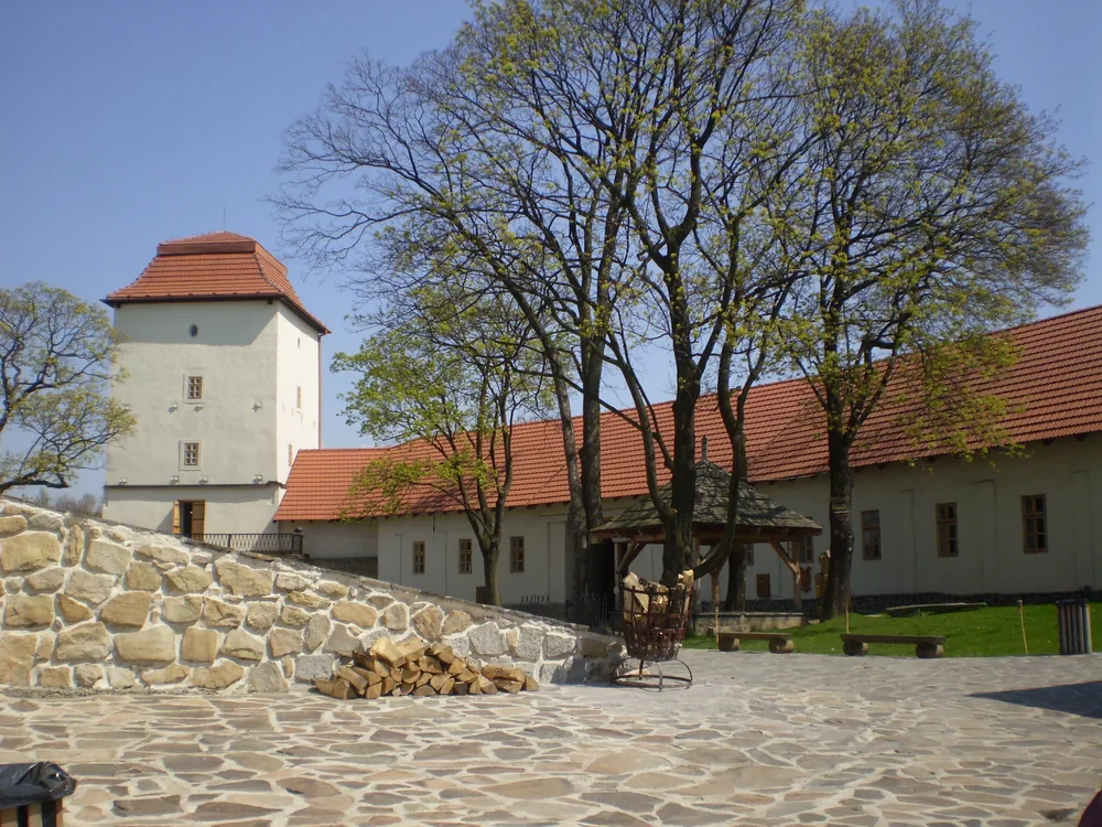 Silesian Ostrava Castle (Slezskoostravský hrad) at the confluence of the Lučina and Ostravice rivers — the restored medieval border fortress of the Silesia-Moravia boundary, now a heritage site within Ostrava's industrial cityscape