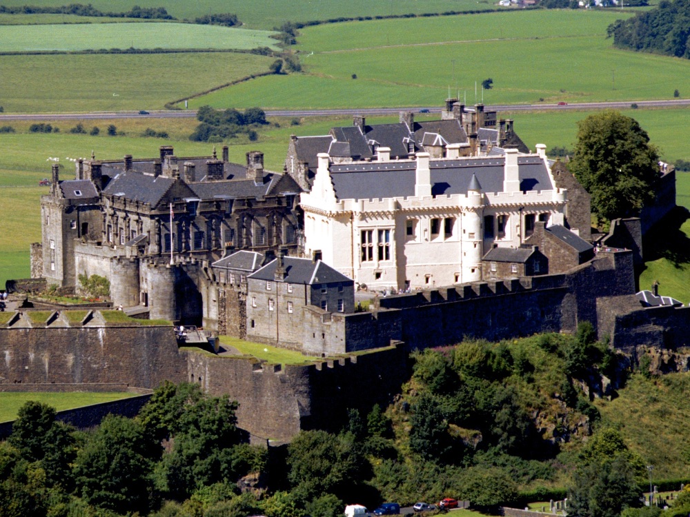 Stirling Castle on its volcanic rock above the Forth Valley, with the Wallace Monument visible in the distance
