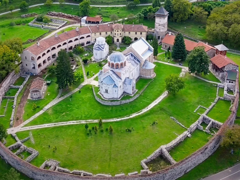 Studenica Monastery in central Serbia — the UNESCO-listed 12th-century fortified Serbian Orthodox monastery founded by Stefan Nemanja, with white marble churches and 13th-century Byzantine frescoes