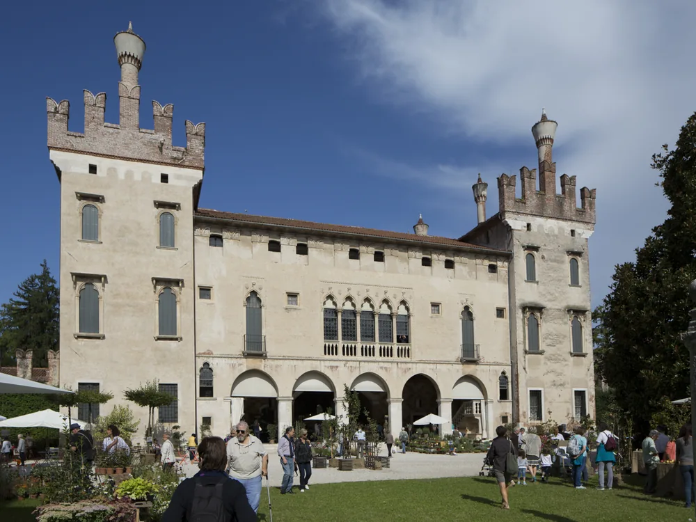 Thiene Castle (Palazzo Porto Colleoni) in the Veneto, Italy — a 15th-century Venetian palazzo behind a crenellated castle wall and twin towers