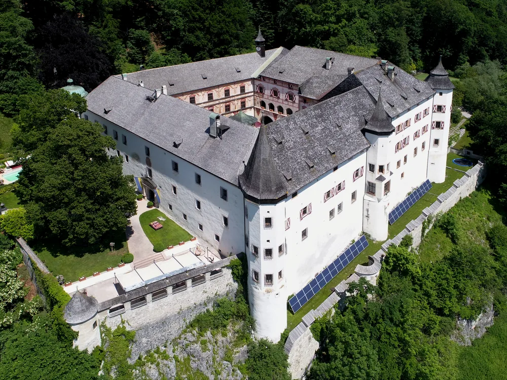 Tratzberg Castle (Schloss Tratzberg) above the Inn Valley in Tyrol, Austria — the privately-inhabited Renaissance castle with its corner turrets and stepped gables in the forested hillside above Stans