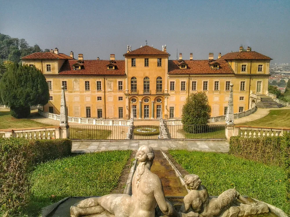 Villa della Regina on its terraced hillside above Turin — the Baroque queens' retreat of the House of Savoy, with formal gardens, a historic vineyard, and a panoramic view across the Po plain to the Alps