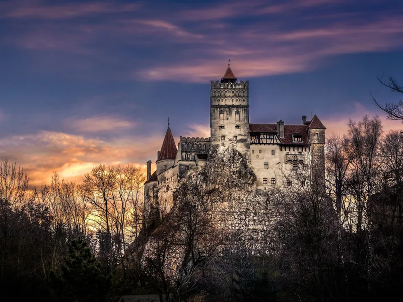 Bran Castle perched on its Transylvanian rock above the mountain pass — the anchor of the Transylvania Castle Route