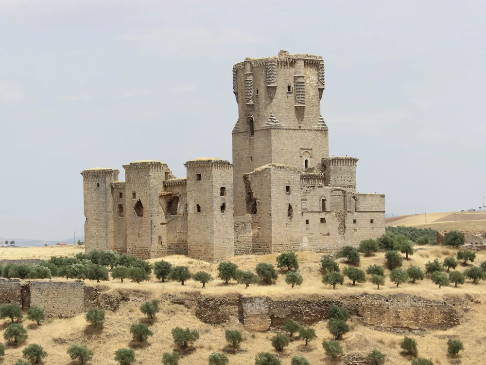 Belmez Castle on its quartzite rock outcrop and Belalcázar Castle's Gothic keep in the Los Pedroches comarca, Córdoba province, Spain