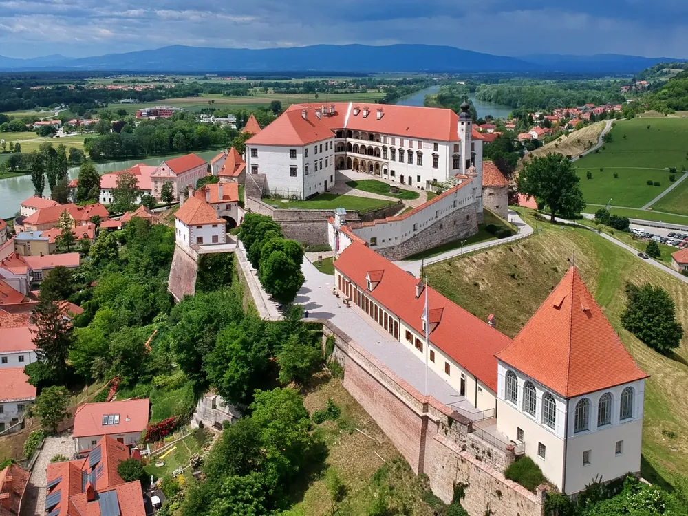 Ptuj Castle above the rooftops of Slovenia's oldest town, seen from across the Drava river