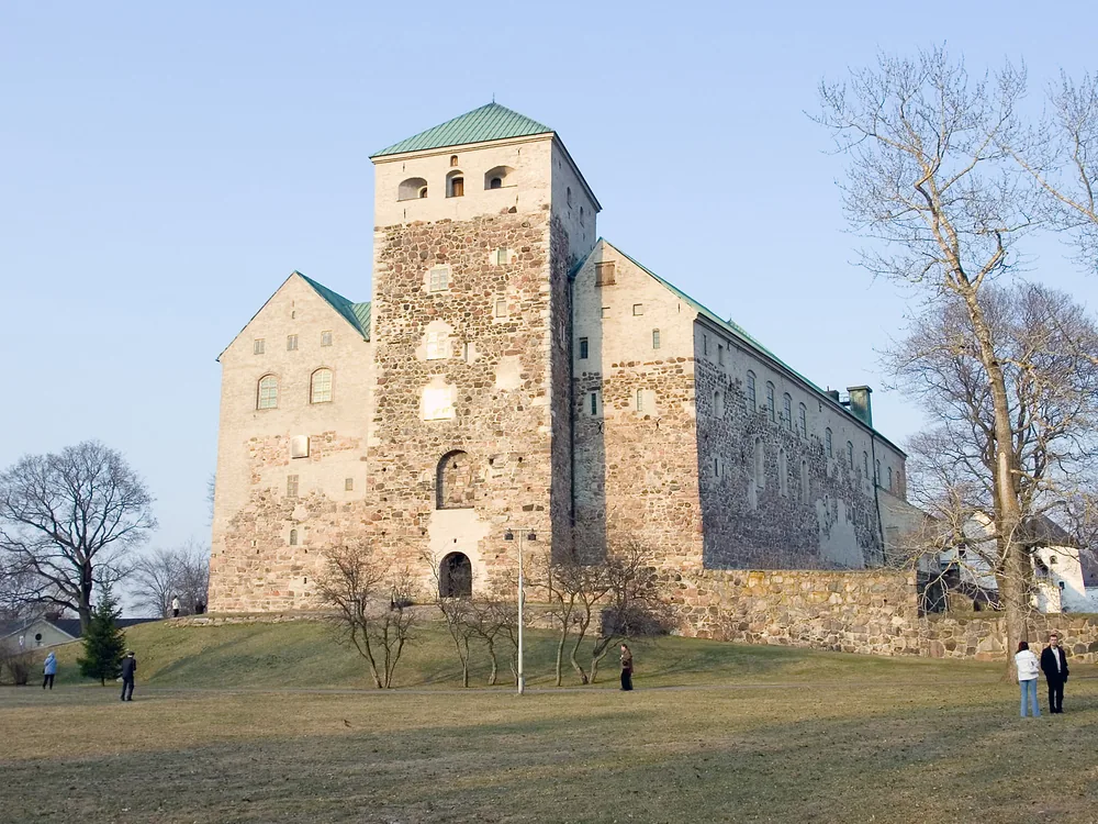 Turku Castle's grey granite towers at the mouth of the Aura River, Finland