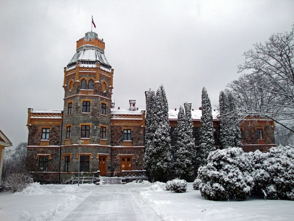 Turaida Castle's red-brick medieval tower above the forested Gauja Valley, Latvia