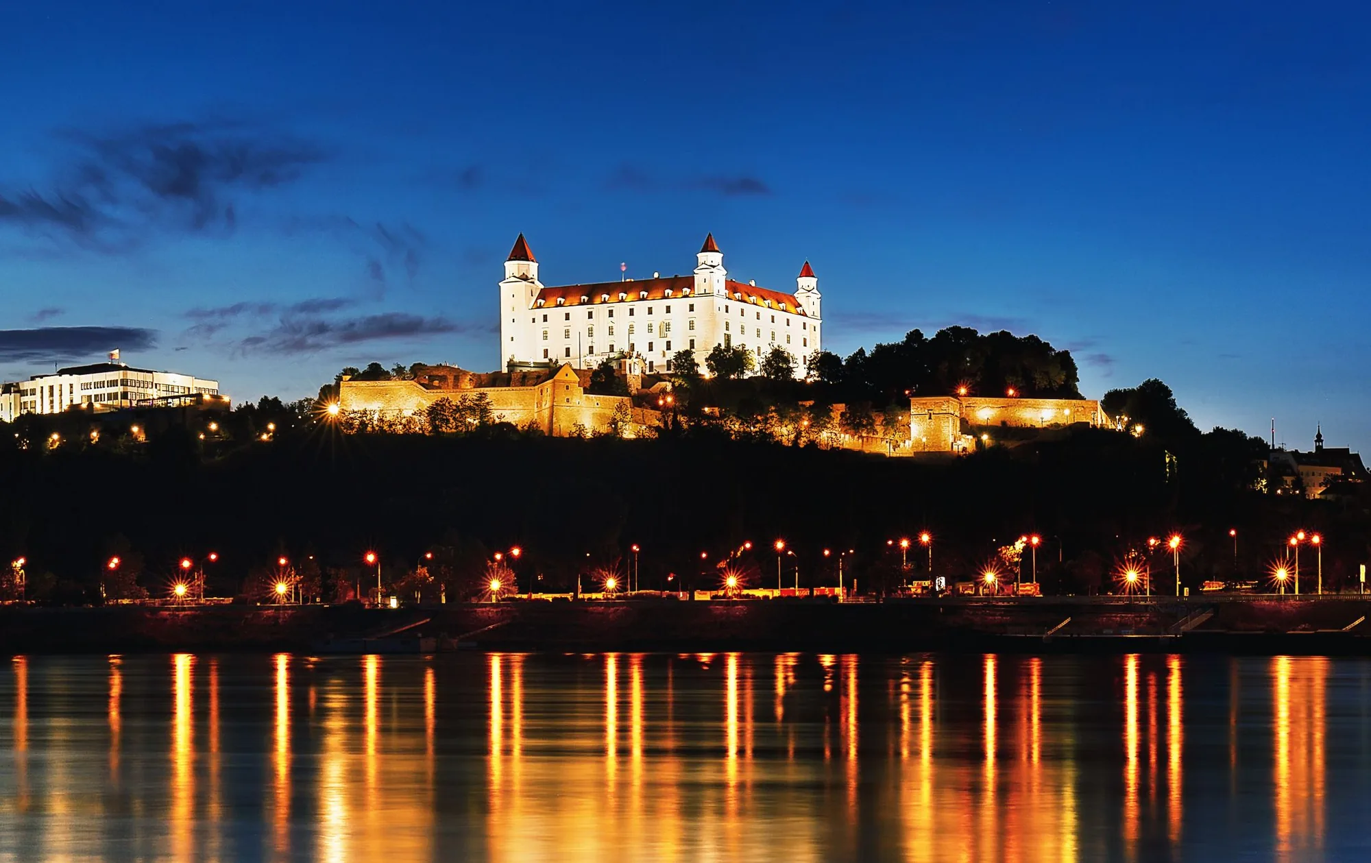 Devín Castle ruins at the confluence of the Danube and Morava rivers, Slovakia, with the Austrian bank visible across the water
