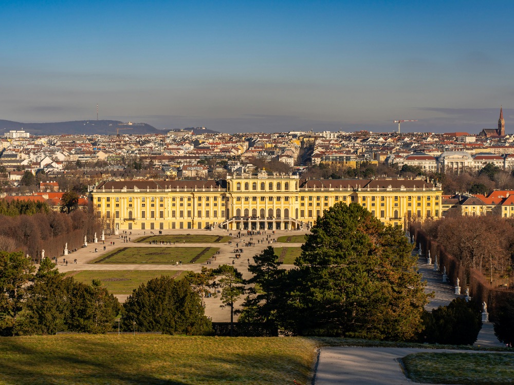 Schönbrunn Palace baroque facade with formal gardens and the Gloriette in the background